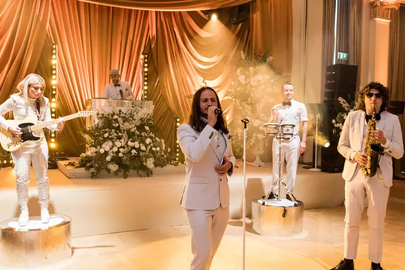 Destination wedding at Adare Manor, County Limerick — live band in all white attire performing on stage during the late night wedding party.