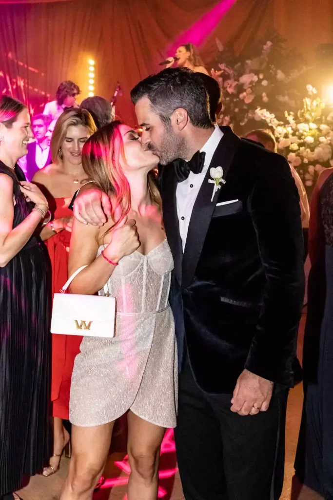 Destination wedding in Ireland at Adare Manor, County Limerick — bride and groom kissing during the wedding party, with the bride wearing a sparkly mini dress.