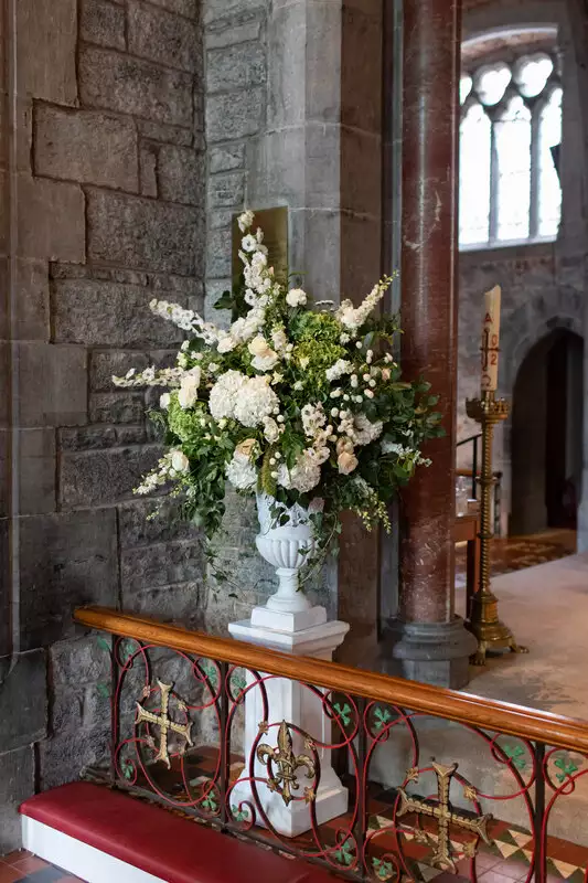 Destination wedding ceremony at Adare Manor, County Limerick — white floral arrangement prepared for a wedding ceremony setting.