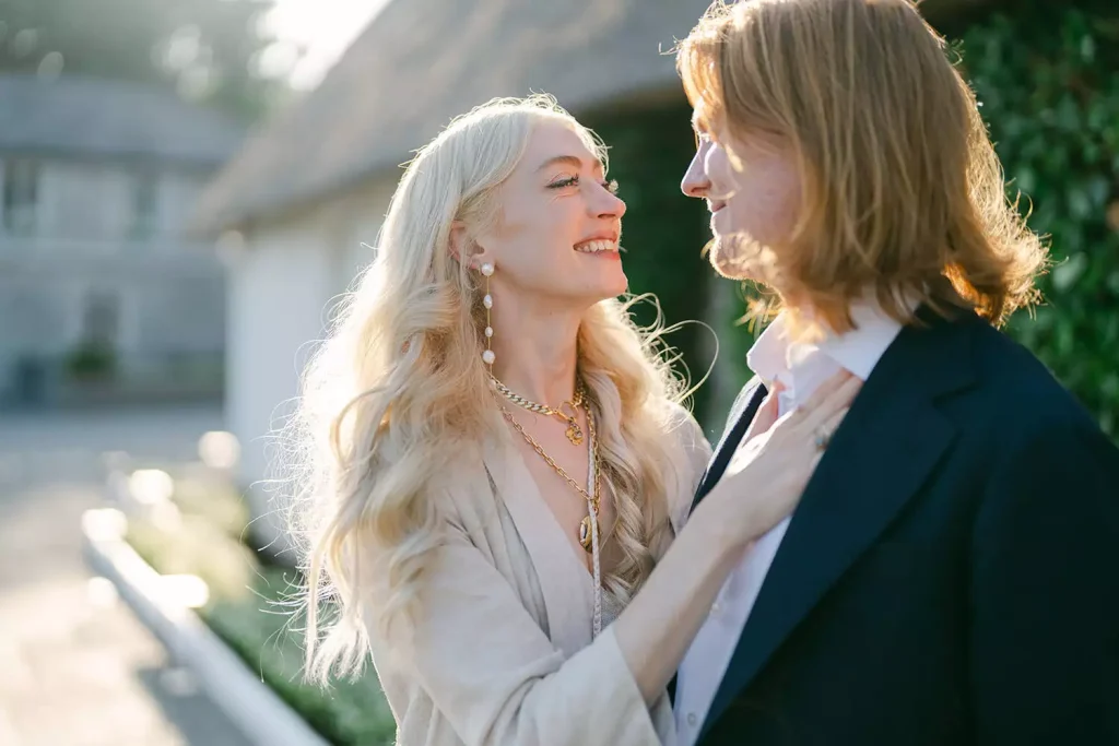 Destination wedding at Ashford Castle, County Mayo — bride and groom in a welcome party portrait, looking at each other with the bride’s hand resting on the groom’s chest.