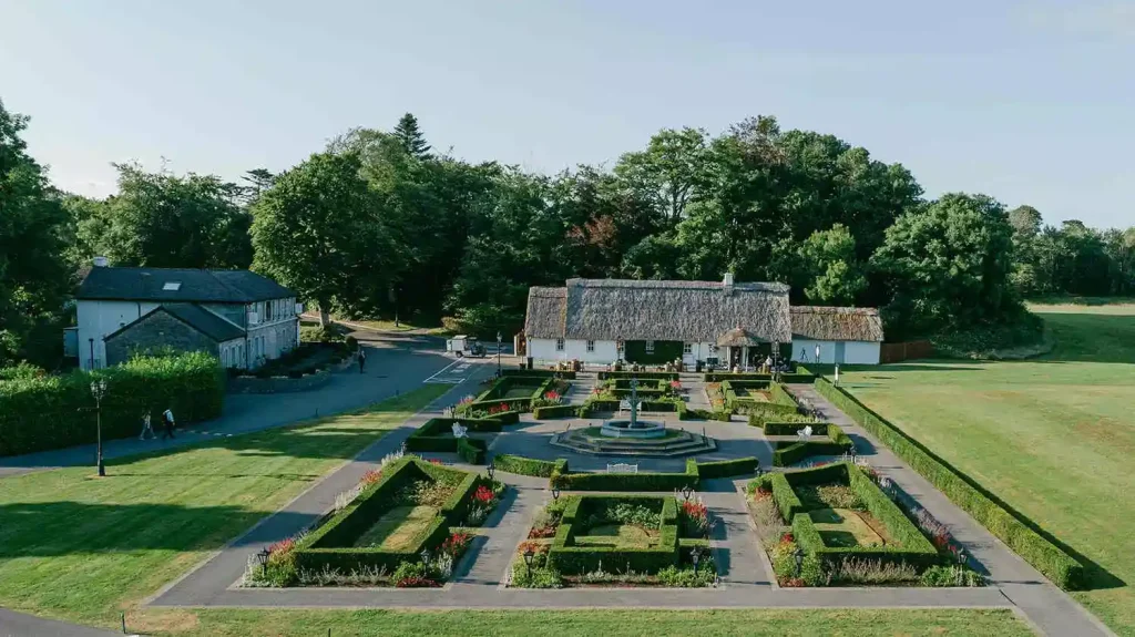 Destination wedding at Ashford Castle, County Mayo — exterior view of Cullen’s At The Cottage framed by manicured gardens within the estate grounds.