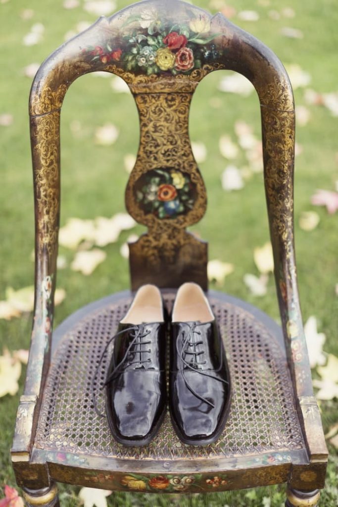 Destination wedding at Ashford Castle, County Mayo — groom’s wedding shoes displayed on a decorative chair during the wedding morning preparations.