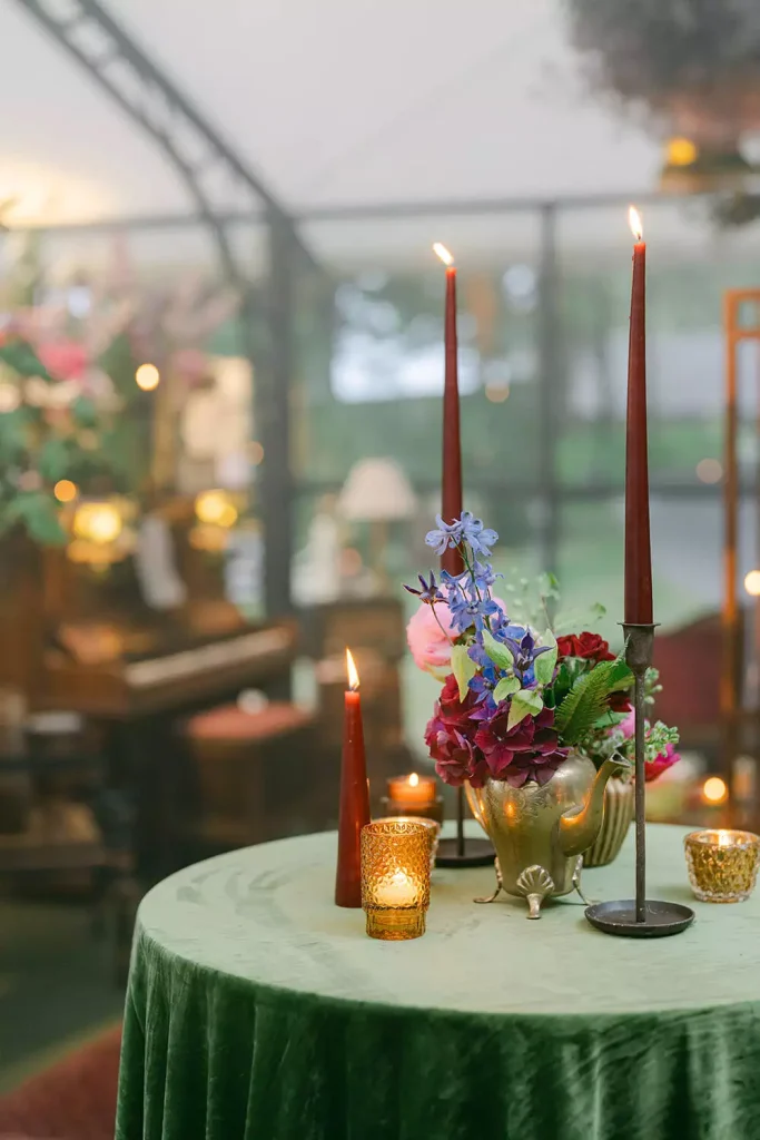 Destination wedding at Ashford Castle, County Mayo — pod table detail featuring candlelight and a small floral arrangement as part of the reception décor.