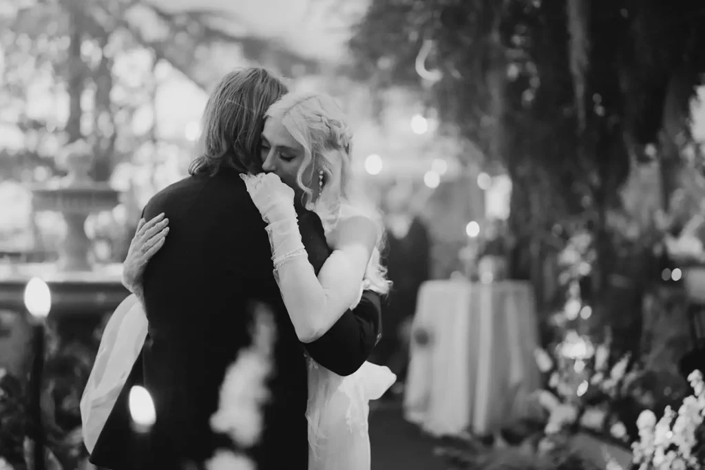 Destination wedding ceremony at Ashford Castle, County Mayo — bride and groom embracing during their first dance at the wedding reception.