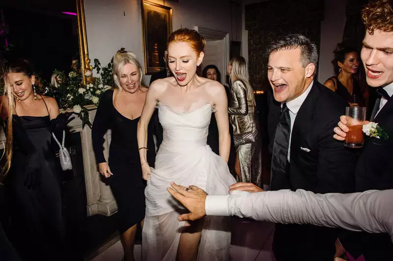 Irish castle wedding at Ballynahinch Castle, County Galway, Ireland — bride dancing at the centre of the late-night party, surrounded by wedding guests on the dance floor.