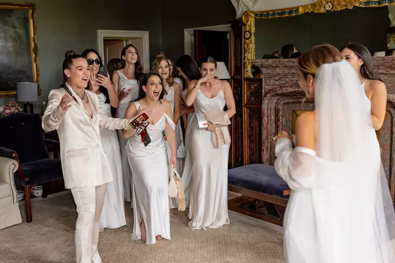 Irish destination wedding at Adare Manor, County Limerick — first look moment with the bride and her bridesmaids, smiling and celebrating together.