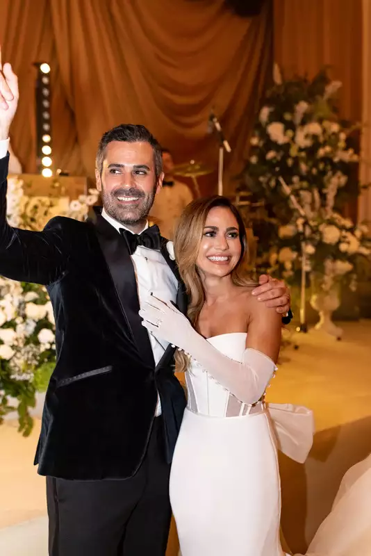 Irish destination wedding at Adare Manor, County Limerick — bride and groom embracing and smiling during the wedding party celebration.