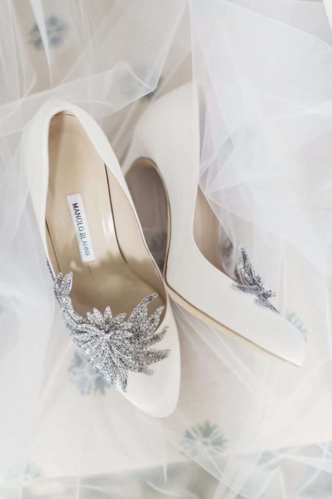 Irish destination wedding at Ashford Castle, County Mayo — detail shot of the bride’s high-heel wedding shoes arranged during the morning preparations.