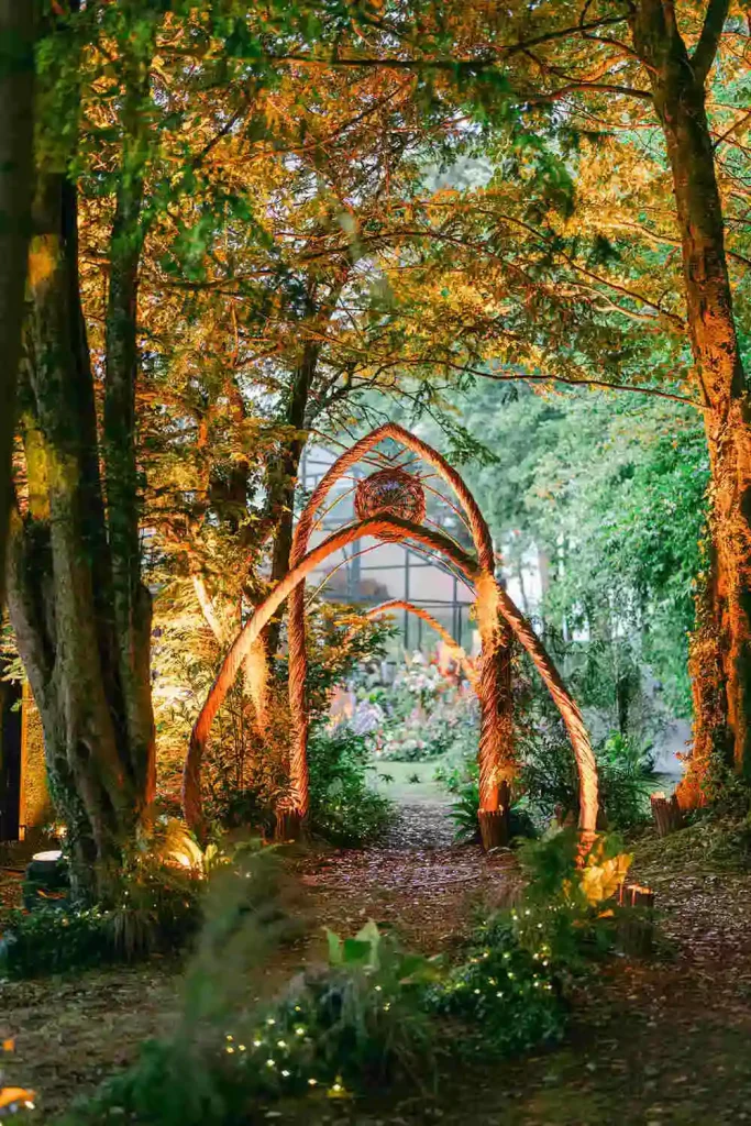 Irish destination wedding at Ashford Castle, County Mayo — custom willow arches set within a forest setting during an outdoor wedding installation.