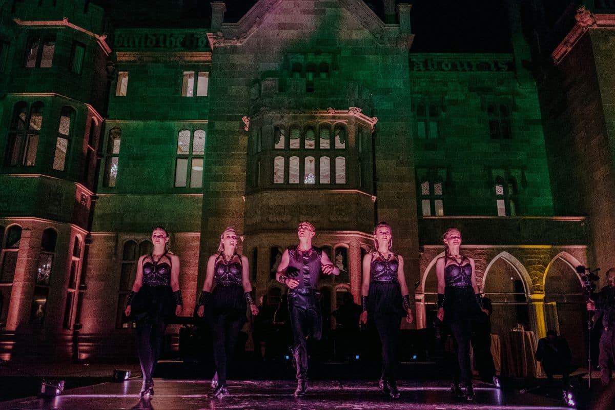 Irish dancers performing in front of Adare Manor during Irish Welcome Party for a wedding celebration.